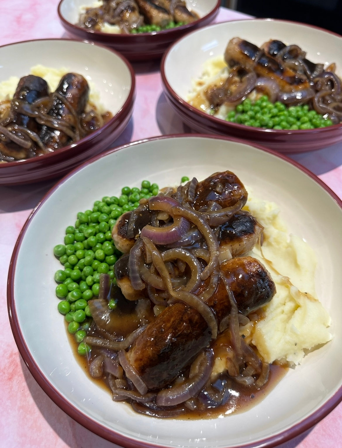 Sausage, caramelised onion gravy & mash